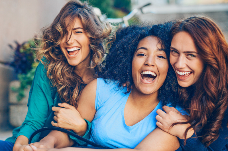 Portrait of four diverse smiling friends | Dr. Doug Orthodontics