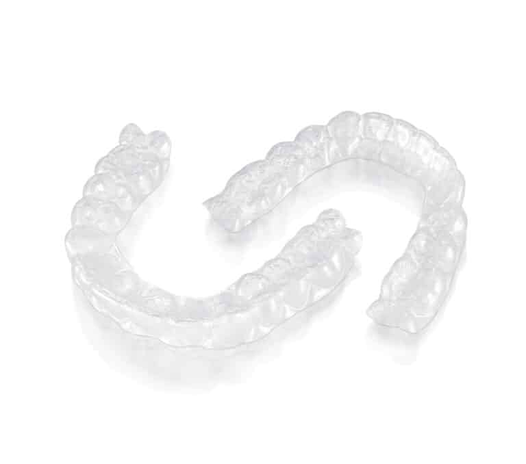 Pair of clear plastic aligner trays | Dr. Doug Orthodontics