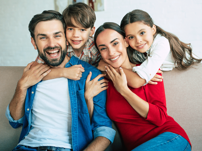 Happy family embracing for a portrait | Dr. Doug Orthodontics